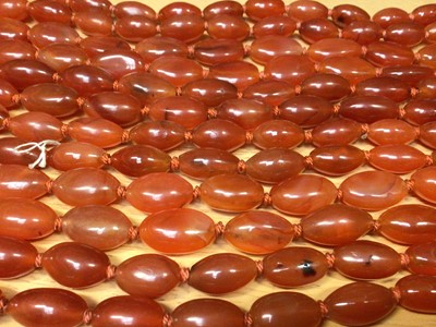 Lot 131 - Six Chinese oval carnelian bead necklaces with silver gilt clasps