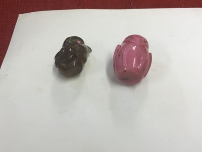 Lot 184 - Two Imperial Russian Carl Fabergé carved hard stone bird ornaments comprising a pink Rhodonite owl with diamond set eyes 2cm high and brown hard stone chick with ruby eyes 1.6 cm, (2)