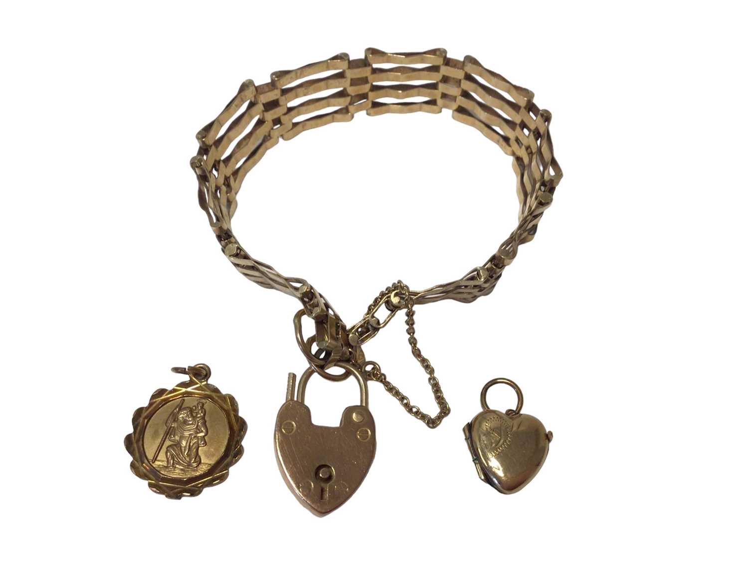 Lot 56 - 9ct gold gate bracelet with padlock clasp, 9ct gold St. Christopher and a 9ct gold heart shaped locket (3)