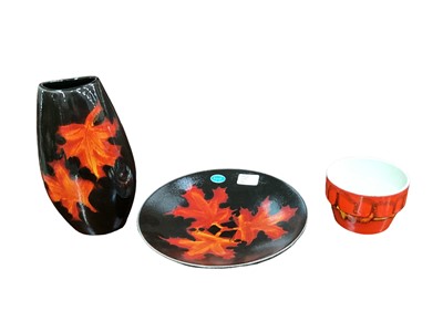 Lot 1115 - Poole Forest Flame vase, together with a matching plate, and a Poole Delphis pot (3)