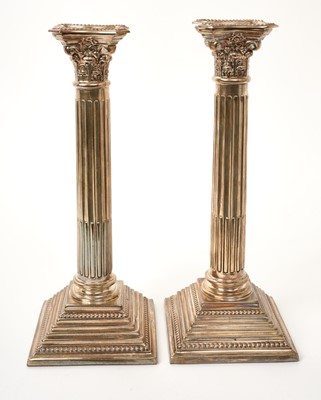 Lot 524 - Pair of silver Corinthian column candlesticks together with a silver three piece cruet set