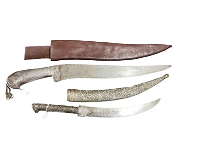 Lot 825 - Indo Persian Pesh - Kabz knife in leather sheath, together with another Middle Eastern dagger in white metal scabbard. (2)