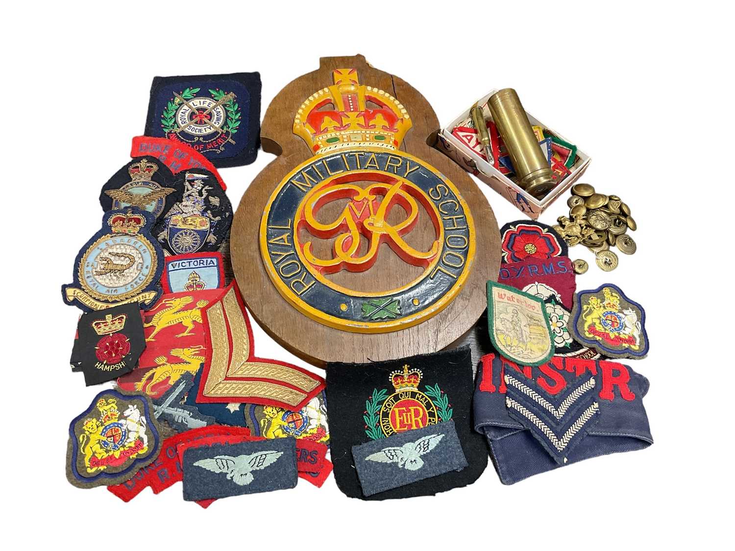 Lot 771 - Collection various cloth military badges, together with a large carved wood Royal Military School badge.