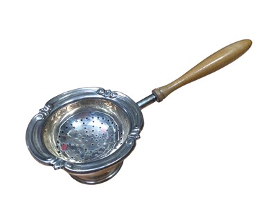Lot 166 - 1960s silver tea strainer with turned wood handle and silver stand, silver trumpet vase and two silver topped glass vanity jars