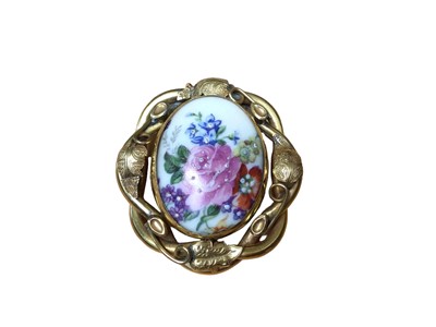 Lot 171 - Victorian gilt metal foliate scroll brooch with a revolving centre depicting an oval porcelain plaque with floral decoration on one side and a glazed photograph compartment to the other, 6cm x 5.5c...