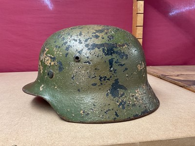 Lot 785 - Second World War Nazi German M35 pattern Luftwaffe steel helmet, with camouflage painted exterior, with chinstrap and liner, the liner inscribed Peter Schnitzhofer. N.B. we believe he was a P.O.W....