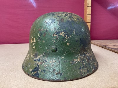 Lot 785 - Second World War Nazi German M35 pattern Luftwaffe steel helmet, with camouflage painted exterior, with chinstrap and liner, the liner inscribed Peter Schnitzhofer. N.B. we believe he was a P.O.W....