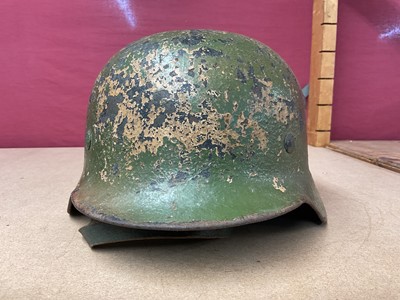 Lot 785 - Second World War Nazi German M35 pattern Luftwaffe steel helmet, with camouflage painted exterior, with chinstrap and liner, the liner inscribed Peter Schnitzhofer. N.B. we believe he was a P.O.W....