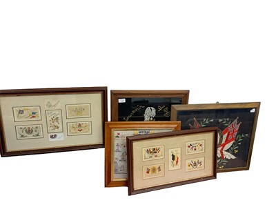 Lot 797 - Two glazed frames containing First World War silk postcards, together with three other military pictures / tapestries (5)