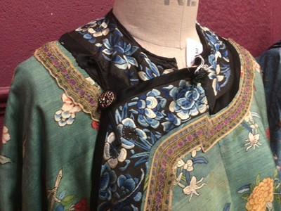 Lot 2180 - 19th century Chinese woman's blue woven silk robe. All over flowers, grapes and butterflies. Pink silk lining.