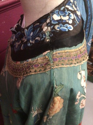 Lot 2180 - 19th century Chinese woman's blue woven silk robe. All over flowers, grapes and butterflies. Pink silk lining.