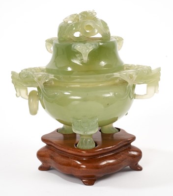 Lot 656 - Chinese carved green jade pot and cover on a wooden stand