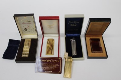 Lot 2539 - Cartier Les Must de Cartier gold plated cigarette lighter in original Cartier box with guarantee card dated 11.3.1984, Christian Dior gold plated lighter, S.J. Dupont lighter in box, various other...