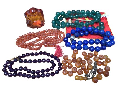 Lot 220 - Adventurine jade bead necklace on 14ct gold clasp, lapis lazuli bead necklace with 14ct white gold clasp, two other bead necklaces, loose amber beads and a carved resin Buddha figure