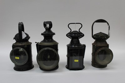 Lot 2549 - Group of four black railway lamps, the largest 32cm high