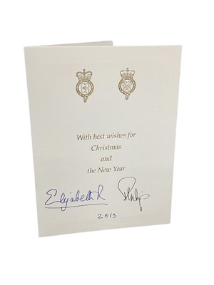 Lot 152 - H.M.Queen Elizabeth II and H.R.H. The Duke of Edinburgh, signed 2013 Christmas card with twin gilt ciphers to cover, twin colour portrait photographs of the Royal couple to the interior with envelo...