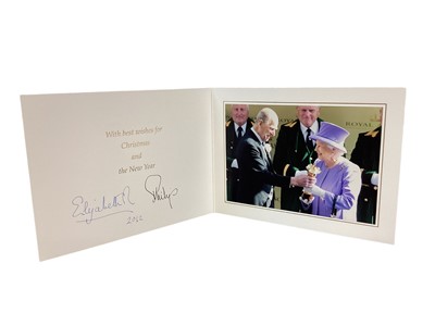 Lot 153 - H.M.Queen Elizabeth II and H.R.H. The Duke of Edinburgh, signed 2012 Christmas card with twin gilt ciphers to cover, colour photograph of the Royal couple to the interior with the Duke presenting T...