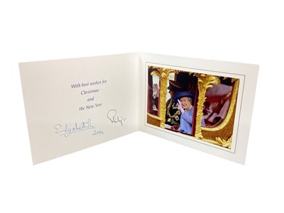 Lot 161 - H.M.Queen Elizabeth II and H.R.H. The Duke of Edinburgh, signed 2002 Christmas card with twin gilt ciphers to cover, colour photograph of the Royal couple in the State coach to the interior with en...