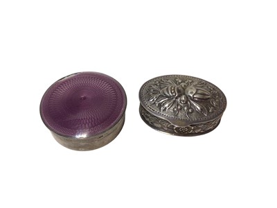 Lot 209 - Mappin & Webb silver and purple enamel round pill box and a continental embossed silver oval box (2)