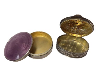 Lot 209 - Mappin & Webb silver and purple enamel round pill box and a continental embossed silver oval box (2)