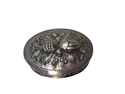 Lot 209 - Mappin & Webb silver and purple enamel round pill box and a continental embossed silver oval box (2)