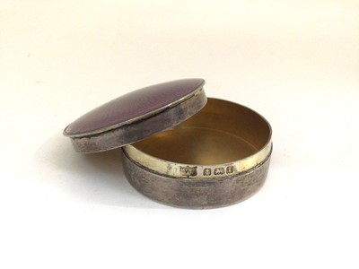 Lot 209 - Mappin & Webb silver and purple enamel round pill box and a continental embossed silver oval box (2)