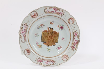 Lot 293 - Chinese export famille rose plate, unusually decorated with a figure holding an inscribed banner, Qianlong