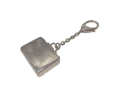 Lot 107 - Asprey silver suitcase key ring with engraved travel labels (London, 2007)