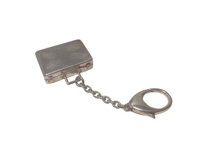 Lot 107 - Asprey silver suitcase key ring with engraved travel labels (London, 2007)