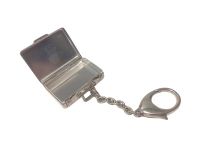 Lot 107 - Asprey silver suitcase key ring with engraved travel labels (London, 2007)