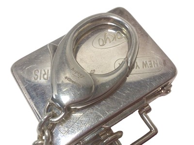 Lot 107 - Asprey silver suitcase key ring with engraved travel labels (London, 2007)