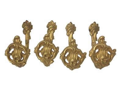 Lot 912 - Set of four 19th century gilt metal curtain tie-backs, in the rococo style, impressed marks, 20cm high