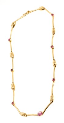 Lot 610 - Ilias Lalaounis 18ct gold and pink tourmaline necklace with articulated gold links interspaced by seven pink tourmaline cabochons, signed, length 41cm. In red suede pouch/case.