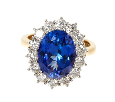 Lot 615 - Good quality tanzanite and diamond cluster ring with an oval mixed cut tanzanite weighing approximately 4.97cts surrounded by a border of 14 round brilliant cut diamonds estimated to weigh approxim...