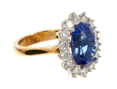 Lot 615 - Good quality tanzanite and diamond cluster ring with an oval mixed cut tanzanite weighing approximately 4.97cts surrounded by a border of 14 round brilliant cut diamonds estimated to weigh approxim...