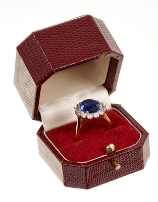 Lot 615 - Good quality tanzanite and diamond cluster ring with an oval mixed cut tanzanite weighing approximately 4.97cts surrounded by a border of 14 round brilliant cut diamonds estimated to weigh approxim...