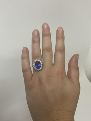 Lot 615 - Good quality tanzanite and diamond cluster ring with an oval mixed cut tanzanite weighing approximately 4.97cts surrounded by a border of 14 round brilliant cut diamonds estimated to weigh approxim...