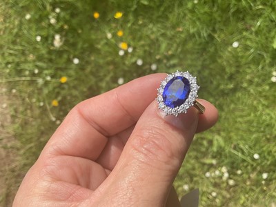 Lot 615 - Good quality tanzanite and diamond cluster ring with an oval mixed cut tanzanite weighing approximately 4.97cts surrounded by a border of 14 round brilliant cut diamonds estimated to weigh approxim...
