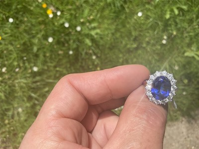 Lot 615 - Good quality tanzanite and diamond cluster ring with an oval mixed cut tanzanite weighing approximately 4.97cts surrounded by a border of 14 round brilliant cut diamonds estimated to weigh approxim...