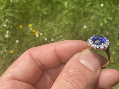 Lot 615 - Good quality tanzanite and diamond cluster ring with an oval mixed cut tanzanite weighing approximately 4.97cts surrounded by a border of 14 round brilliant cut diamonds estimated to weigh approxim...