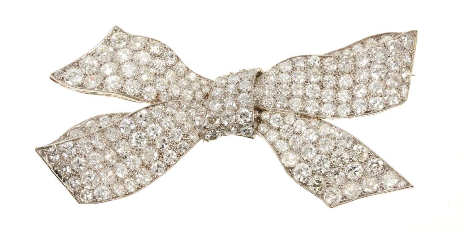 Lot 628 - A fine 1920s diamond bow brooch, the stylised bow with pavé set old cut diamonds in platinum and 18ct white gold setting with pierced gallery. Estimated total diamond weight approximately 7.5cts-8c...