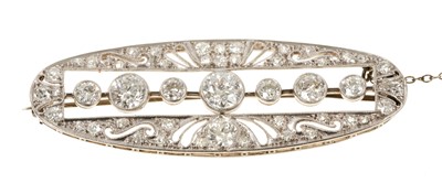 Lot 629 - Edwardian Belle Époque diamond brooch, the oval openwork plaque with old cut diamonds in millegrain setting, the pierced border with further old cut and rose cut diamonds in platinum setting with p...