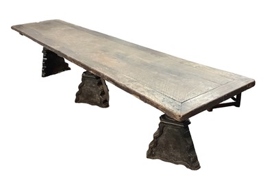 Lot 1523 - Substantial Italian walnut refectory table, the cleated plank top on pyramidal column supports