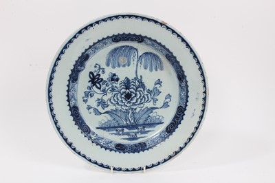 Lot 351 - 18th century blue and white Delftware dish, decorated in the Chinese style with a willow tree and peony pattern, 30.5cm diameter