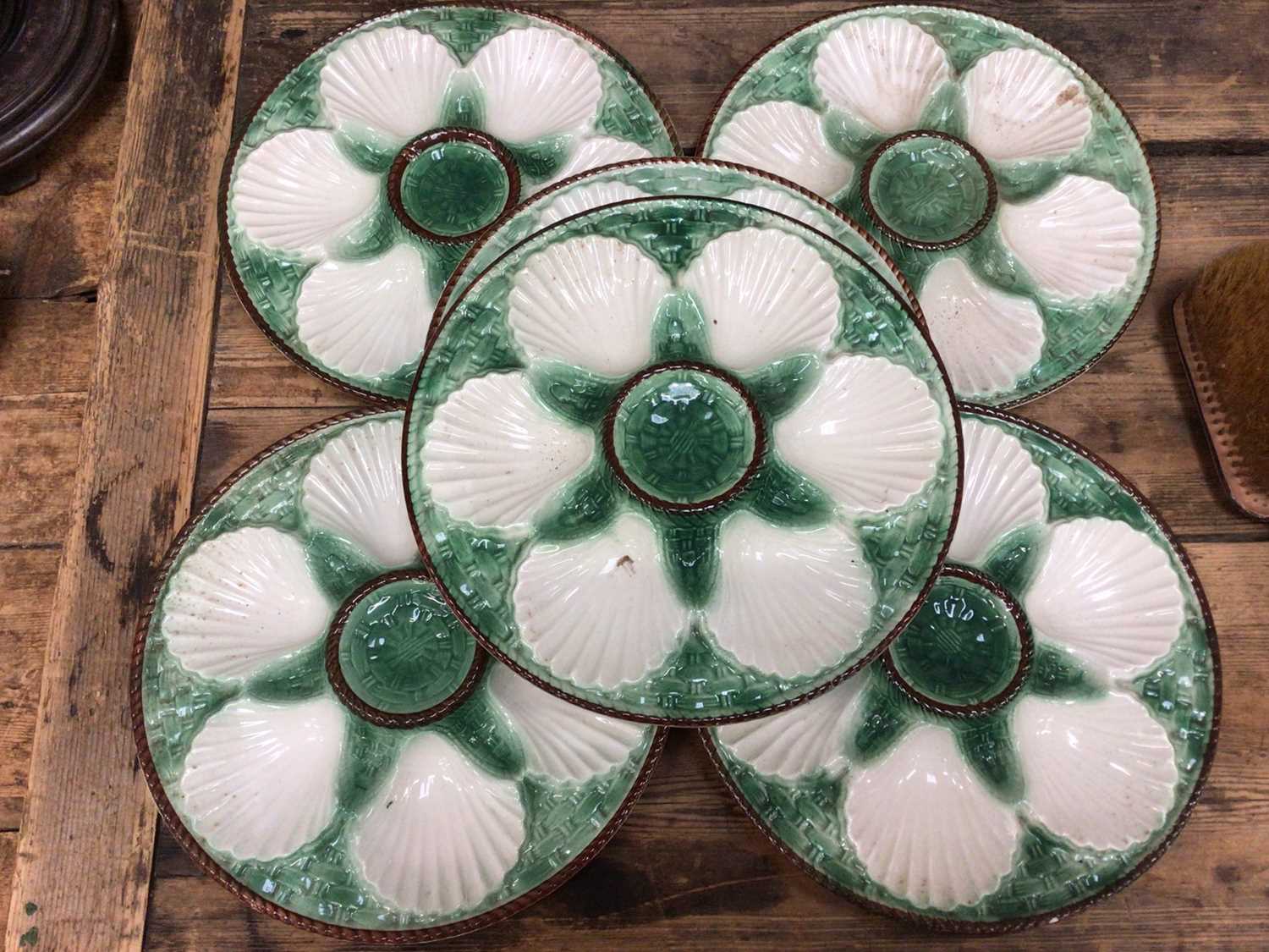 Lot 15 - Set of six French majolica oyster plates with basket weave moulding, painted green and brown, 24cm diameter