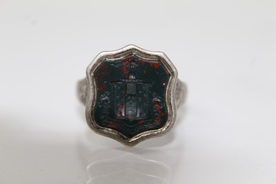 Lot 715 - Victorian-style signet ring with a shield shape bloodstone seal with intaglio armorial family crest in silver setting, ring size R.