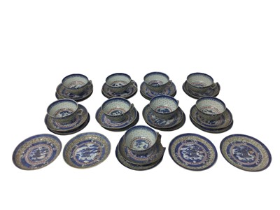 Lot 379 - Chinese rice pattern porcelain tea set, circa 1900, decorated with landscape scenes, including nine cups and 22 saucers