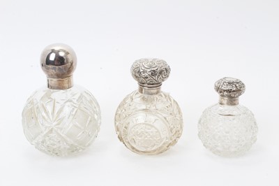 Lot 572 - Edwardian silver mounted cut glass scent bottle of globular form and two others