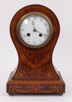 Lot 1071 - Edwardian mantel clock with 8 day striking movement, the circular white enamel dial with Arabic numerals, in a mahogany balloon shape case with marquetry inlaid decoration depicting classical troph...