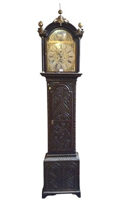 Lot 1089 - 18th century 8 day longcase clock, the arched brass dial with silvered chapter ring and subsidiary date and second dials, in an oak case with later carved decoration, 228cm.